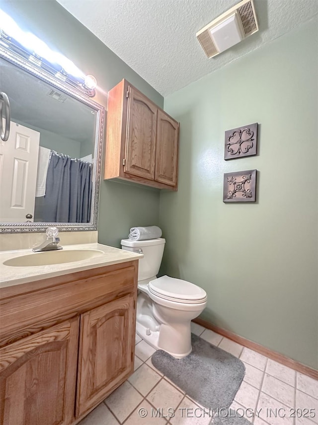 bathroom featuring visible vents, toilet, vanity, a textured ceiling, and tile patterned floors