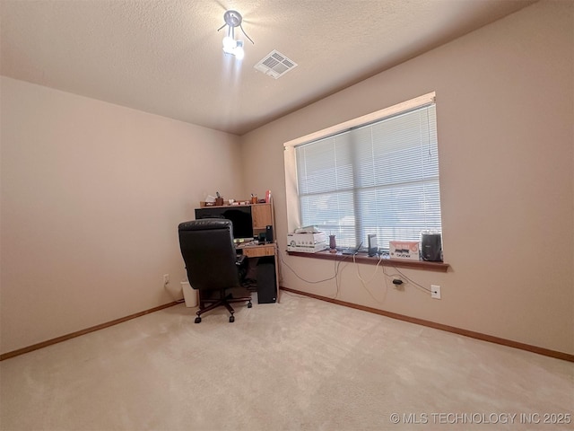 home office featuring baseboards, visible vents, a textured ceiling, and carpet flooring