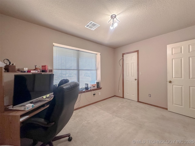 home office with baseboards, visible vents, a textured ceiling, and light colored carpet