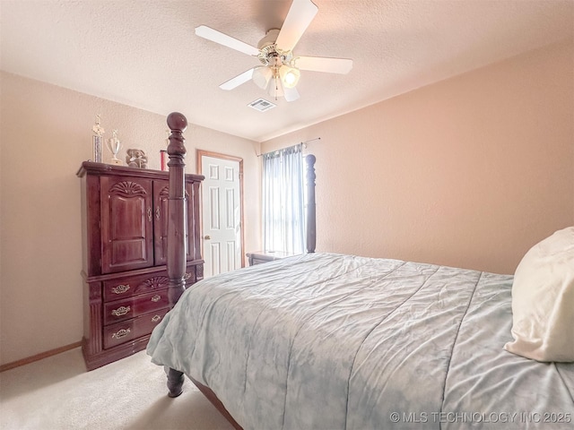 bedroom featuring visible vents, a ceiling fan, carpet flooring, a textured ceiling, and baseboards