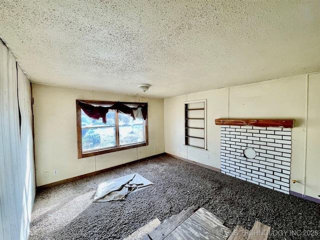 unfurnished living room featuring a textured ceiling, carpet, and baseboards