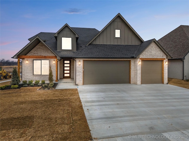 view of front of home featuring an attached garage, brick siding, concrete driveway, roof with shingles, and board and batten siding