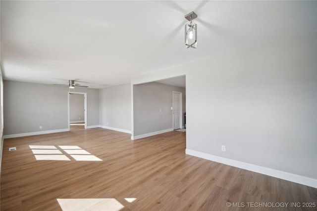 8301 E 133rd St S, Bixby, OK 74008 - unfurnished living room featuring a ceiling fan, baseboards, and light wood-style floors