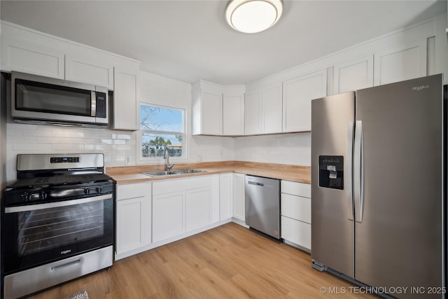 8301 E 133rd St S, Bixby, OK 74008 - kitchen featuring a sink, wooden counters, stainless steel appliances, and white cabinets