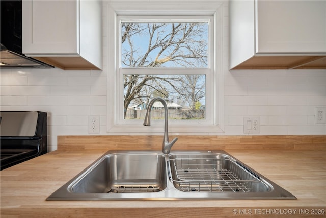 8301 E 133rd St S, Bixby, OK 74008 - kitchen featuring wooden counters, white cabinetry, tasteful backsplash, a sink, and range