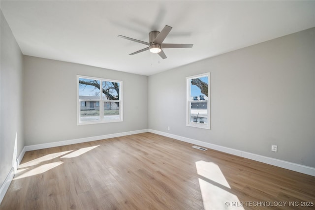 8301 E 133rd St S, Bixby, OK 74008 - empty room with visible vents, wood finished floors, and a wealth of natural light