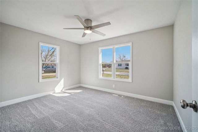 8301 E 133rd St S, Bixby, OK 74008 - spare room featuring carpet floors, baseboards, a ceiling fan, and visible vents