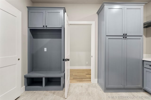 mudroom with light wood finished floors and baseboards