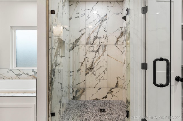bathroom featuring a marble finish shower