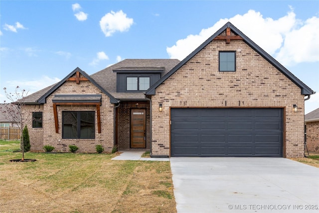 view of front of house featuring brick siding, driveway, a shingled roof, and a front yard