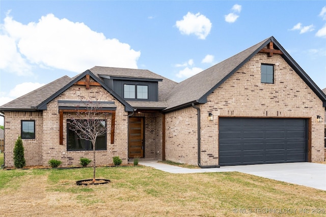 view of front facade with a front lawn, brick siding, roof with shingles, and concrete driveway