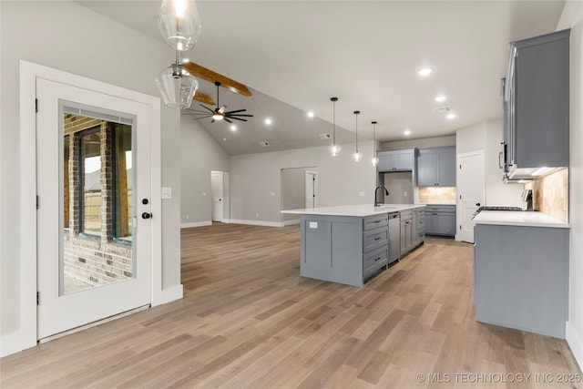 kitchen with light countertops, dishwasher, gray cabinets, hanging light fixtures, and open floor plan