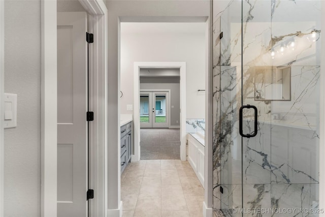 bathroom with vanity and a marble finish shower