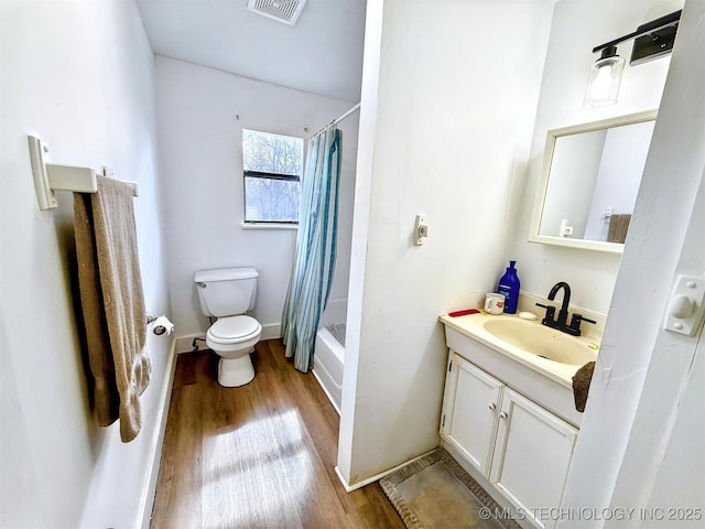 full bath with baseboards, visible vents, toilet, wood finished floors, and vanity