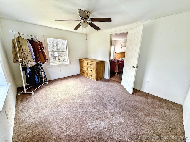 unfurnished bedroom with carpet floors and a ceiling fan