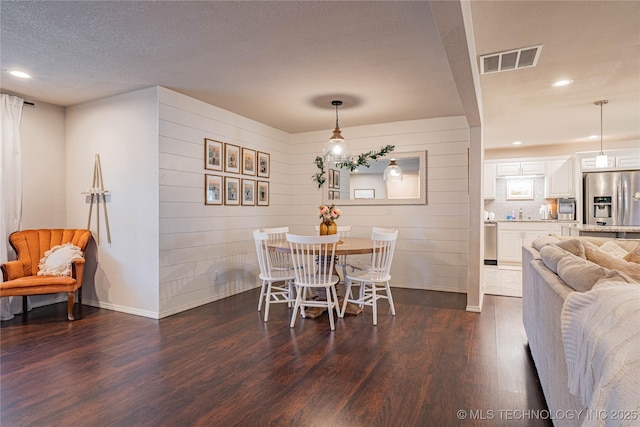 dining area with dark wood-style flooring, recessed lighting, visible vents, a textured ceiling, and baseboards