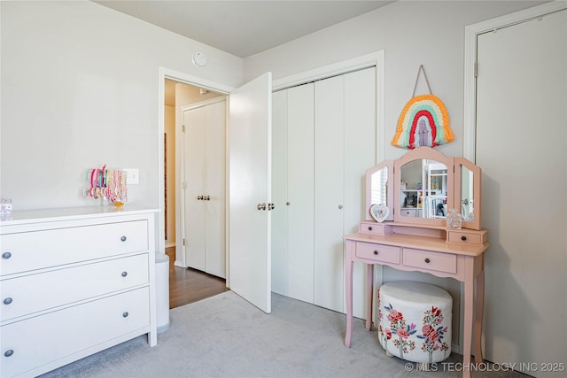 bedroom with a closet and light carpet