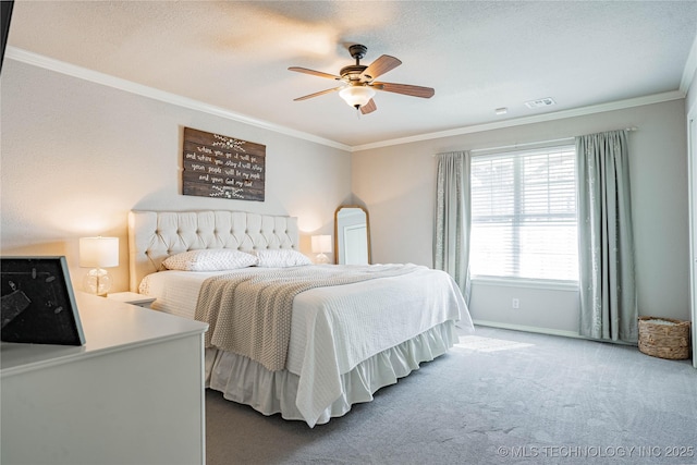 bedroom featuring a ceiling fan, visible vents, carpet flooring, and ornamental molding