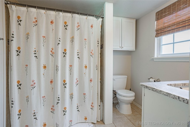 bathroom featuring toilet, a shower with curtain, vanity, and tile patterned floors