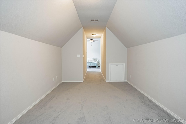 bonus room with carpet, visible vents, lofted ceiling, and baseboards