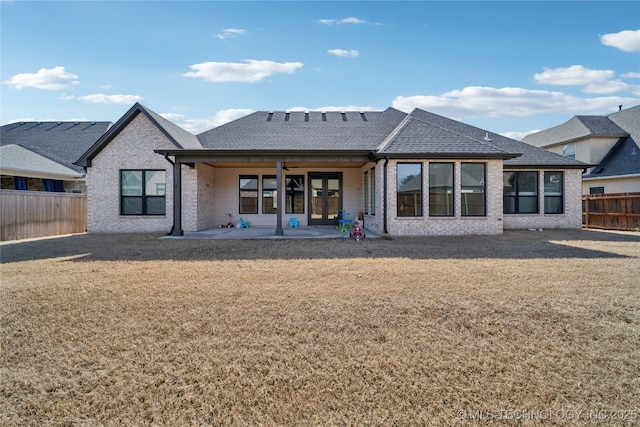 rear view of house with french doors, brick siding, a patio, ceiling fan, and a fenced backyard