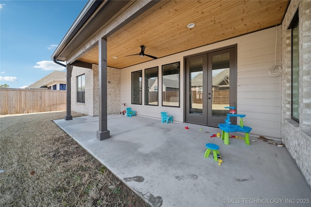 view of patio featuring french doors, fence, and a ceiling fan