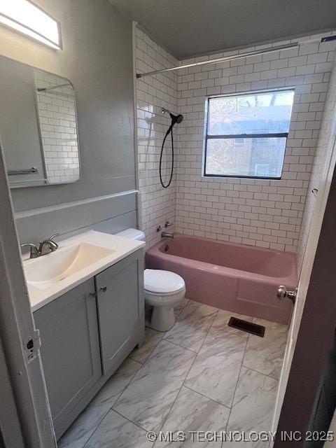 bathroom featuring visible vents, toilet, marble finish floor, vanity, and washtub / shower combination