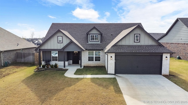 view of front facade with brick siding, a shingled roof, fence, concrete driveway, and a front yard