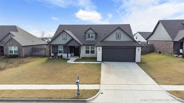 view of front of property with brick siding, driveway, a front lawn, and fence