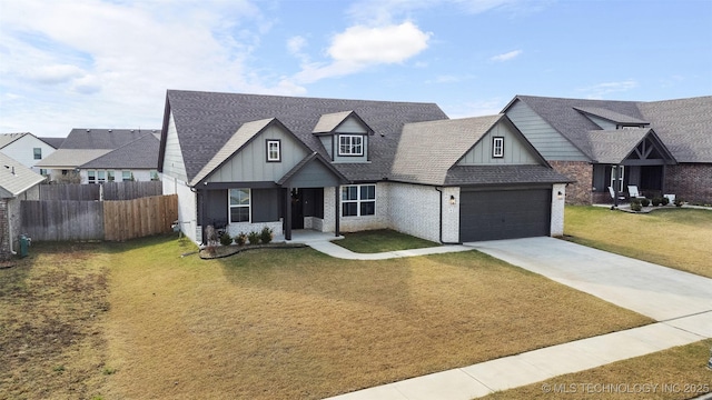 view of front of house with board and batten siding, fence, a garage, driveway, and a front lawn