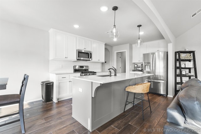 1423 E Roanoke Pl, Broken Arrow, OK 74011 - kitchen with appliances with stainless steel finishes, a sink, dark wood-style flooring, recessed lighting, and light countertops