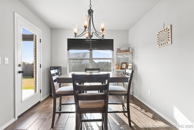 1423 E Roanoke Pl, Broken Arrow, OK 74011 - dining area featuring a chandelier, wood finished floors, and baseboards
