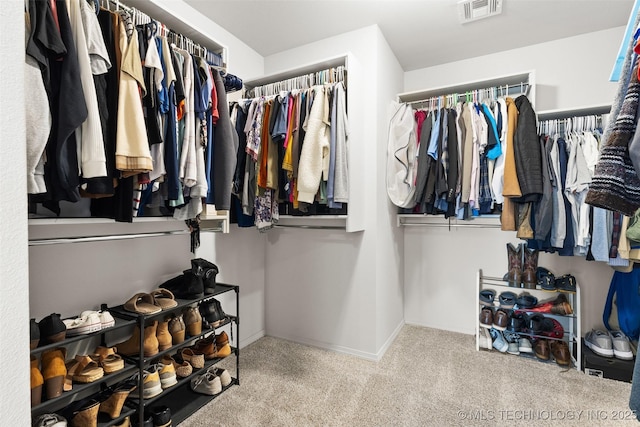 walk in closet featuring carpet and visible vents