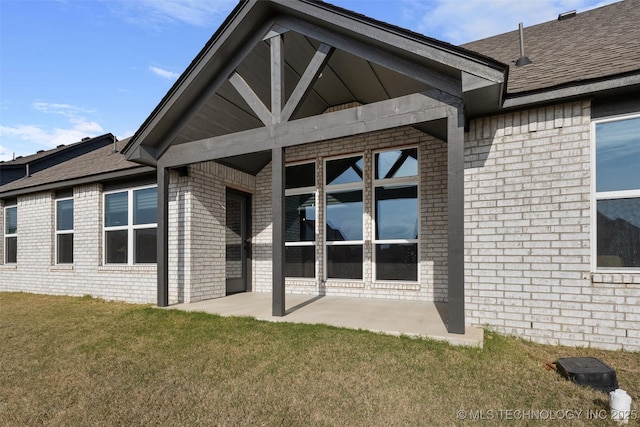 1423 E Roanoke Pl, Broken Arrow, OK 74011 - back of house featuring brick siding, a yard, a patio area, and a shingled roof