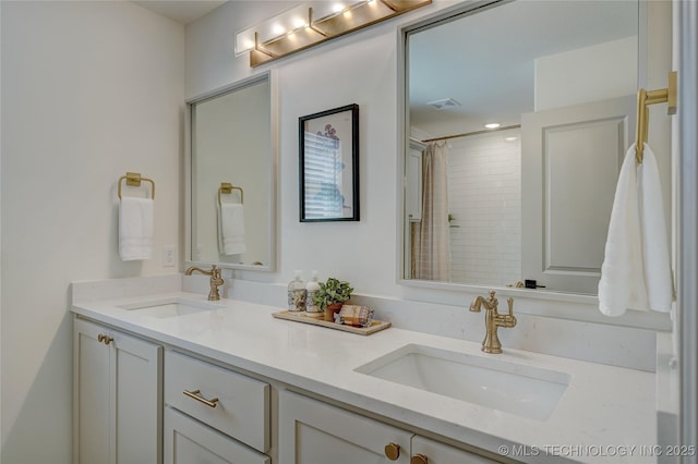 full bathroom featuring a shower with curtain, visible vents, a sink, and double vanity