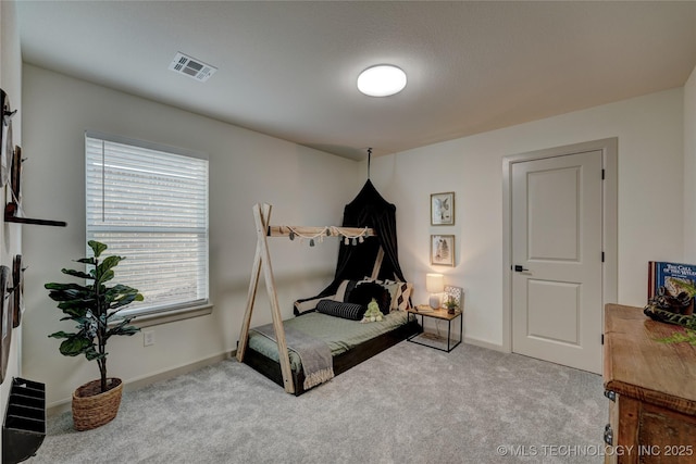 carpeted bedroom with visible vents and baseboards