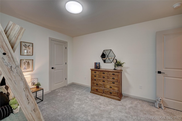 bedroom featuring carpet and baseboards