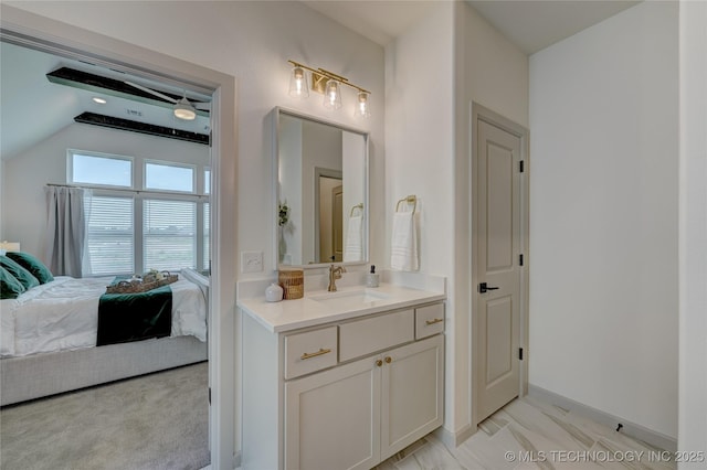 bathroom featuring vaulted ceiling, connected bathroom, and vanity