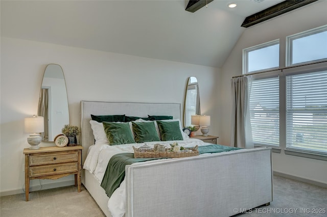 bedroom with baseboards, vaulted ceiling, and light colored carpet