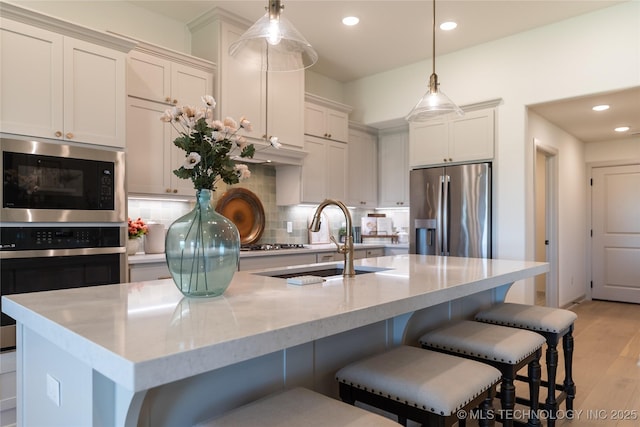 kitchen with light wood finished floors, tasteful backsplash, stainless steel fridge with ice dispenser, built in microwave, and a sink