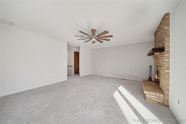 unfurnished living room featuring a textured ceiling, a fireplace, a ceiling fan, and carpet