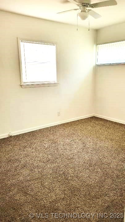 spare room featuring carpet, baseboards, and ceiling fan