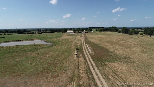 birds eye view of property featuring a water view and a rural view