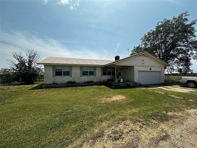 single story home featuring a garage, brick siding, driveway, a front lawn, and a chimney