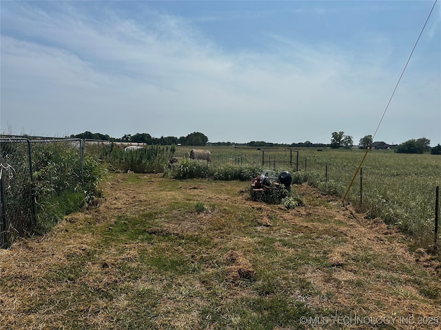 view of yard featuring fence and a rural view