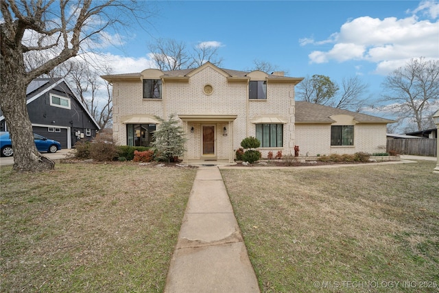 view of front of home with brick siding and a front yard