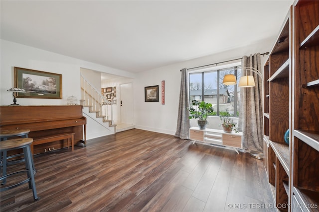 foyer entrance featuring baseboards, stairway, and dark wood-style flooring