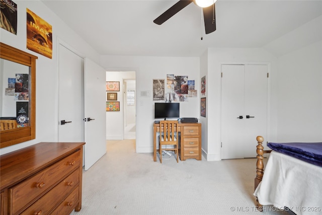 bedroom featuring light carpet, a closet, and a ceiling fan