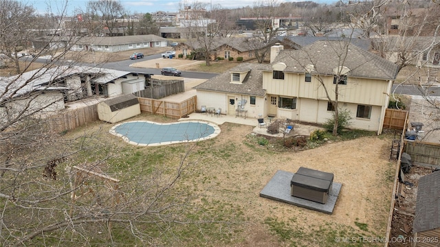 view of pool featuring a patio, a fenced backyard, and a residential view