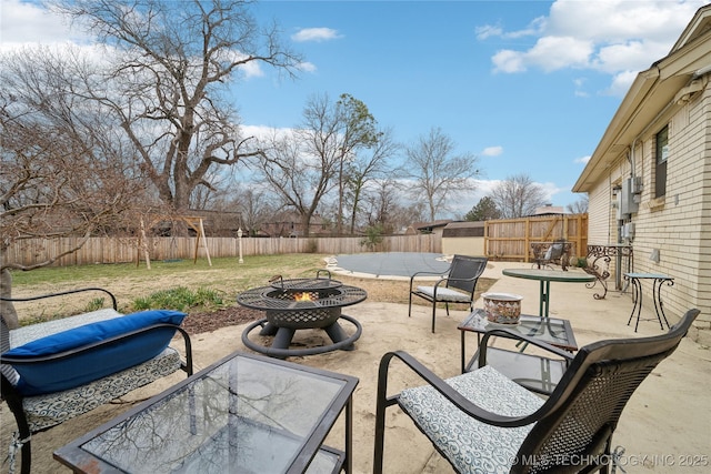 view of patio / terrace with an outdoor fire pit and a fenced backyard